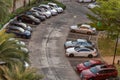 Car parking lot outdoor with trees in front of hall building in the evening. Outdoor parking lot with fresh ozone and green Royalty Free Stock Photo