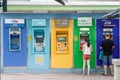 People using outdoor ATM cash machine Royalty Free Stock Photo