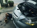 Bangkok, Thailand - March 6 , 2017:Asian auto mechanic working under the car at the garage to repair.