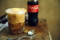 Bangkok ,Thailand - 2022 March 28 Caca Cola on vanilla ice cream in glass on the wooden table