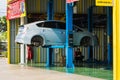 Bangkok, Thailand - March, 25, 2021 :Car service center. Vehicle raised on lift at maintenance station. Auomobile repair and check Royalty Free Stock Photo