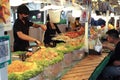 Bangkok, Thailand:March5,2023-Chefs cooking in the street food shop with defocused group of tourists waiting for the food in