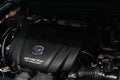 BANGKOK, THAILAND - MARCH 29, 2021: Closeup The Mazda logo and the SKYACTIV Technology engine in New Mazda car. SKYACTIV is a