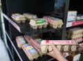 Female hand holding egg tray and Empty shelves of shampoo in supermarket Panic buyer for hoarding food, Coronavirus Covid-19 conce Royalty Free Stock Photo