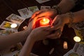 Bangkok,Thailand,March.15.20.Female hands hold a lighted candle in the dark at night. A fortune teller performs a magical. Ritual