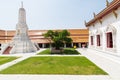 BANFemale monk in white robe walking in the backyard of Golden Buddha temple complex in Bangkok, Thailand Royalty Free Stock Photo