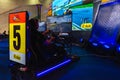 Bangkok, Thailand - March 31, 2019 : Gamers driving simulation car with reality screen E Sport technology game GP e-racing game at