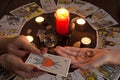 Bangkok,Thailand,March.15.20.The girl holds wedding rings on her hand with Tarot cards,crystals,a magic ball and a lighted candle.