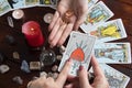 Bangkok,Thailand,March.15.20.The girl holds wedding rings on her hand with Tarot cards with heart,crystals,a magic ball and a