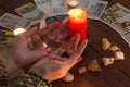 Bangkok,Thailand,March.15.20.The girl holds wedding rings on her hand with Tarot cards with heart,crystals,a magic ball and a
