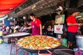 Bangkok, Thailand - March 2019: man cooking seafood at the Chatuchak weekend market street restaurant