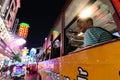 BANGKOK, THAILAND - MARCH 2019: man driving in public bus through China town night market Royalty Free Stock Photo