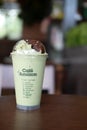 Bangkok, Thailand - March 22, 2020: Milk green tea frappe topping with red beans on wood table at Cafe Amazon are found in every