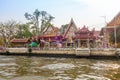 BANGKOK, THAILAND, MARCH, 23, 2018: Outdoor view of stoned buildings of temple at riverside on the Chao Phraya river