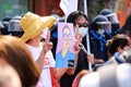 Pro-democracy protesters show a picture of arrested protesters