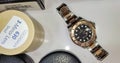 Rolex Yacht master model 126621 with black dial, two tone oyster strap, put on the table with blue neck tie