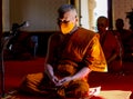 A Thai Buddhist monk wearing a facemask