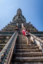 Tourists climbing up and walking down on steep stairs of Wat Arun temple Royalty Free Stock Photo