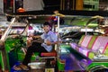 Bangkok, Thailand - March 2019: tuk-tuk taxi driver at China town night market Royalty Free Stock Photo