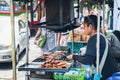 Grilling pork vendor, Chinatown, Bangkok, Thailand