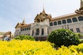 BANGKOK, THAILAND - MARCH 2019: View over Grand Palace and Chakri Maha Prasat hall through the trees and bushes