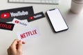 Bangkok, Thailand - March 06, 2019 : Women holding a paper label on the Netflix screen.