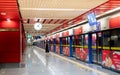 A classic white digital clock and Empty Subway station making the yellow line for people waiting for train coming