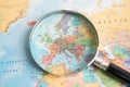 Bangkok, Thailand - May 01, 2022 Europe, Magnifying glass close up with colorful world map Royalty Free Stock Photo