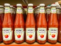 Many bottles of Heinz tomato ketchup on shelf