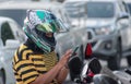 BANGKOK, THAILAND - MAY 02: Motorcycle rider checks mobile at the side of traffic on Petchkasem 69 in Bangkok on May 02, 2020