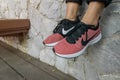 The NIKE pink shoes with red box of women for exercise at the park.