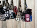 Bangkok, Thailand - May 15, 2018 Old used digital compact cameras of hanging on wooden table, Change the era, Less used