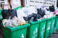 Overflowing garbage bins with household waste