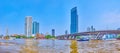 Panorama of Chao Phraya river with fast moving boats and modern highrises and King Taksin the Great Bridge, on May 12 in Bangkok,