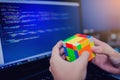 BANGKOK, THAILAND - MAY 15, 2019: Programmer holding Rubik`s cube