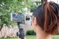 BANGKOK THAILAND - MAY 26: Unnamed woman records video using a Samsung Galaxy smartphone on a Zhiyun Smooth 4 gimbal in Bangkok on