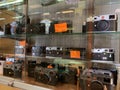 Bangkok, Thailand, May 10, 2019. Various branded DSLR cameras are displayed in glass cabinets on the shelf. In a camera shop