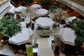 Seating arrangement with umbrellas for upscale French cafe restaurant in shopping mall Bangkok Thailand