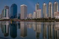 BANGKOK, THAILAND - 7 Nov 2019 :Reflection office building water front a Benjakiti green park Twilight