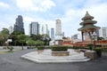 BANGKOK ,THAILAND - NOV 13 : Small monument and traditional Chinese style pagoda with modern business building in background at