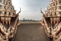 Symmetry view of Loha Prasart Metal Palace at Ratchanaddaram temple beyond the golden temple roof