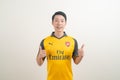 Bangkok, THAILAND - Nov 27, 2021 : Young Asian man wearing Arsenal shirt with white background