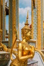 Beautiful traditional gold statues at ornate entrance to Temple of Emerald Buddha in Grand