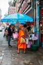 Buddhist monk collecting food at Yaowarat Road, the main street of Chinatown in Bangkok