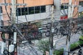 Chaos of power lines on utility poles in downtown Bangkok provide electricity to the city Royalty Free Stock Photo