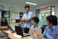 A group of students in a classroom working together on an exercise