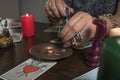 Fortune teller medium lays out Tarot cards and guesses for the future with wedding ring.