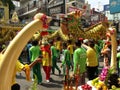 A group of boys walks a dragon in a Festival of the Clans of the Chinese community of Bangkok