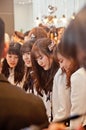 BANGKOK, THAILAND - NOVEMBER 23, 2018: A group members of Thai Idol girl group BNK48, smile at a menu in Gontran Cherrier bakery