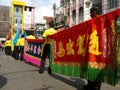A group of men carrying colorful banners at a Chinese Community Clan Festival in Bangkok Royalty Free Stock Photo